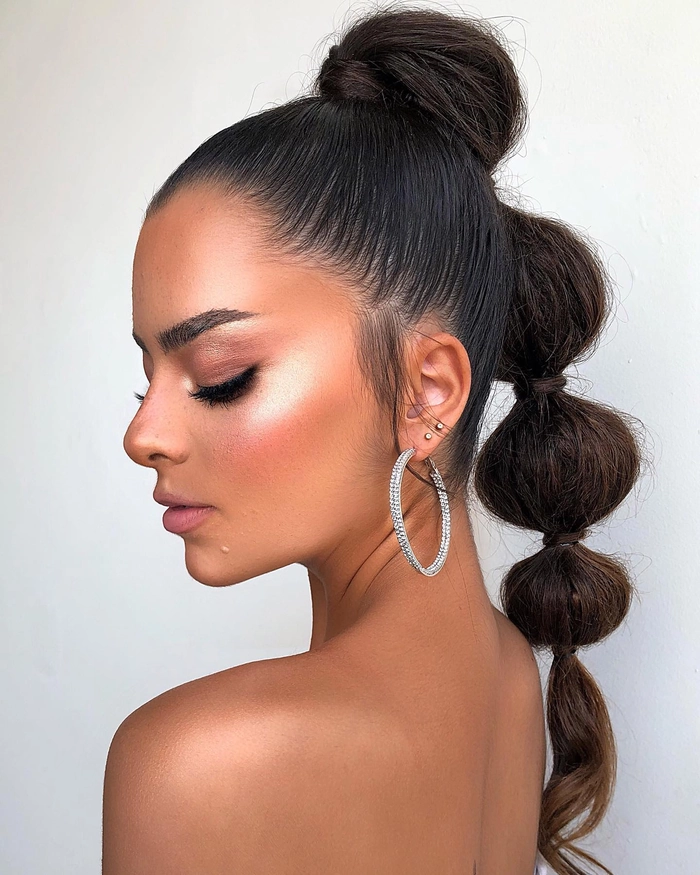 Prom hairstyle featuring multiple small braids styled elegantly for a formal look