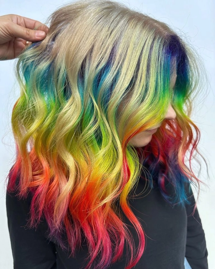 Prom hairstyle featuring vivid rainbow colored hair styled in elegant waves