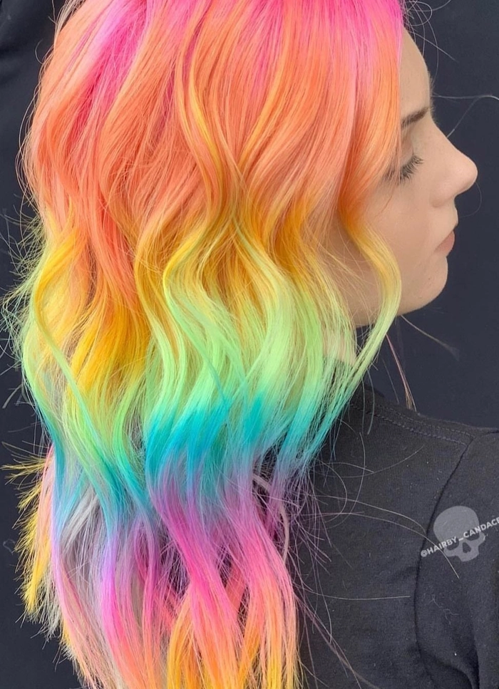 Prom hairstyle featuring vivid rainbow color treated hair styled in elegant waves