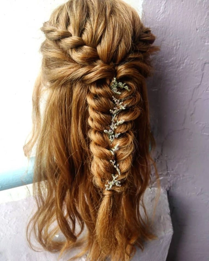 Prom hairstyle featuring multiple small braids woven into an elegant updo