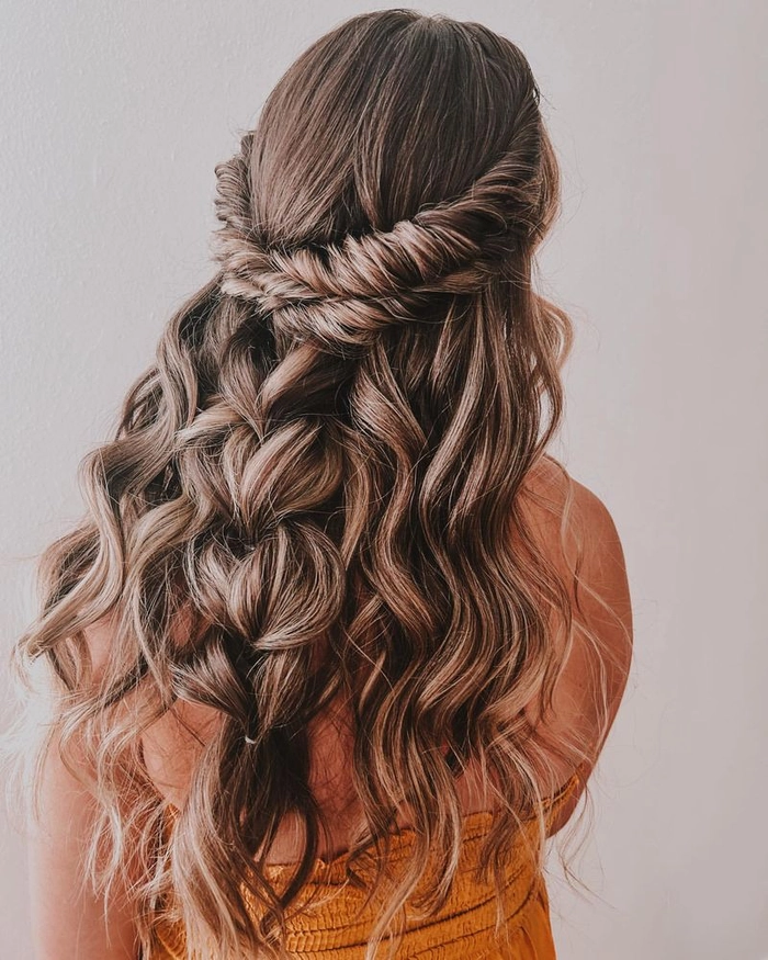Elegant prom hairstyle featuring a twisted halo braid with loose curls