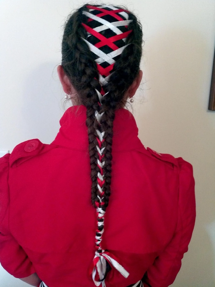 Elegant prom hairstyle featuring a velvet ribbon braided into loose curls