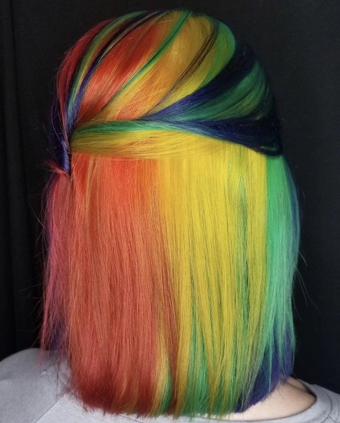 Prom hairstyle featuring a sleek updo on vivid rainbow color treated hair