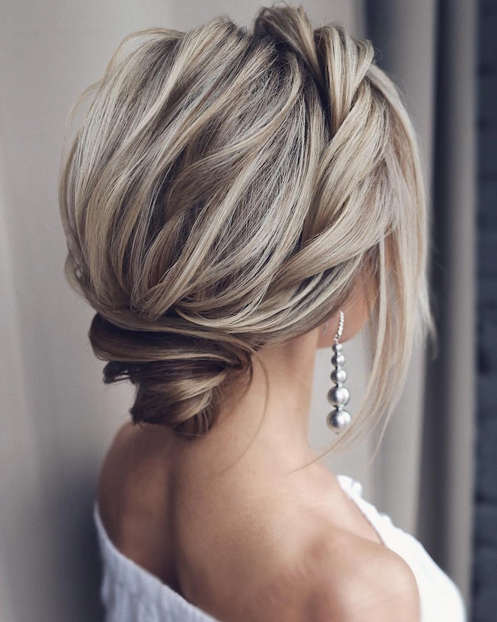 Chic prom hairstyle showcasing a voluminous medium length updo for thick hair Elegant medium length prom updo for thick hair with soft curls