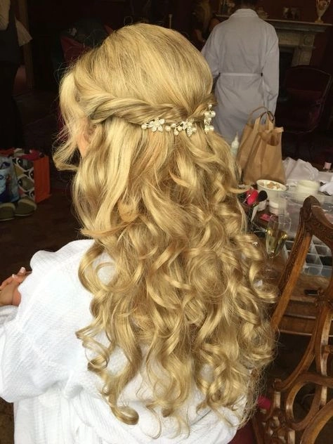 Elegant romantic fairy tale princess prom hairstyle with flowing curls and floral accents