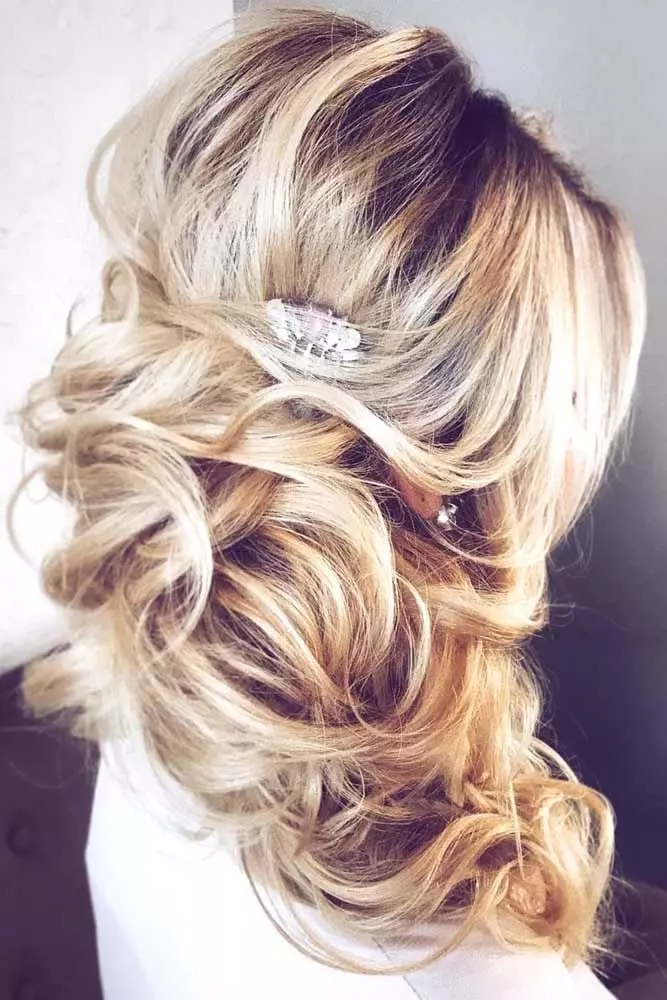 Elegant side swept loose curls perfect for prom night glamour Romantic loose side swept prom hairstyle with soft curls and delicate accessories