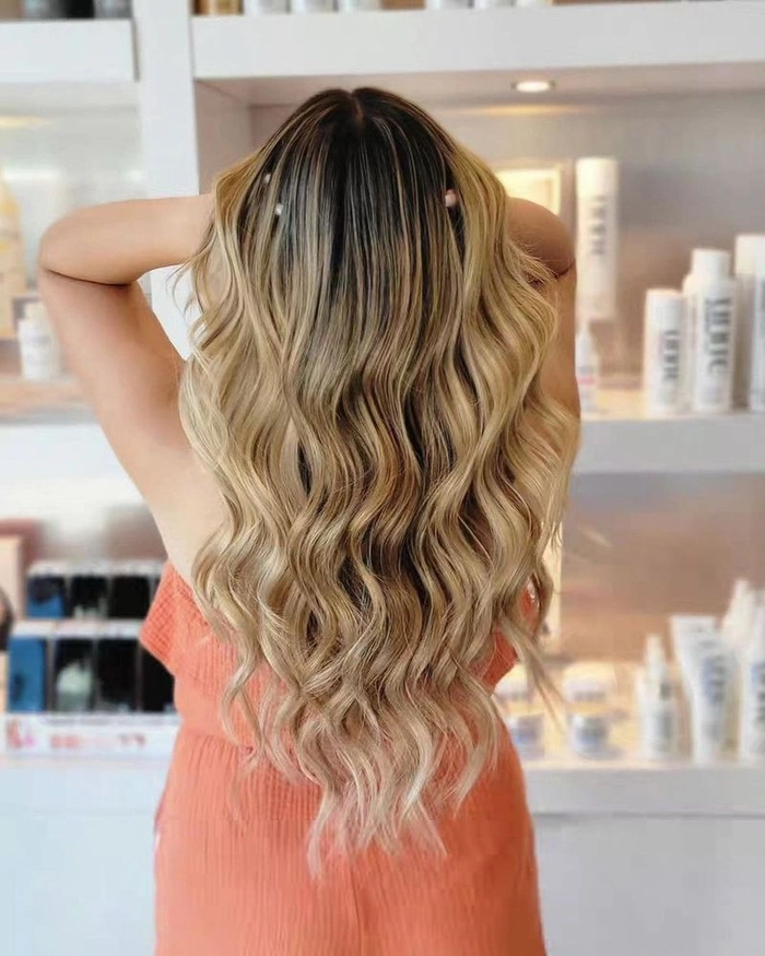 Summer prom hairstyle idea number 2 designed for comfort and style in warm temperatures Elegant summer prom hairstyle perfect for hot weather with loose curls and floral accents