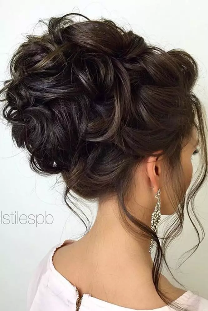 Gorgeous textured top knot hairstyle perfect for prom night glamour Textured top knot prom updo with elegant twists and volume