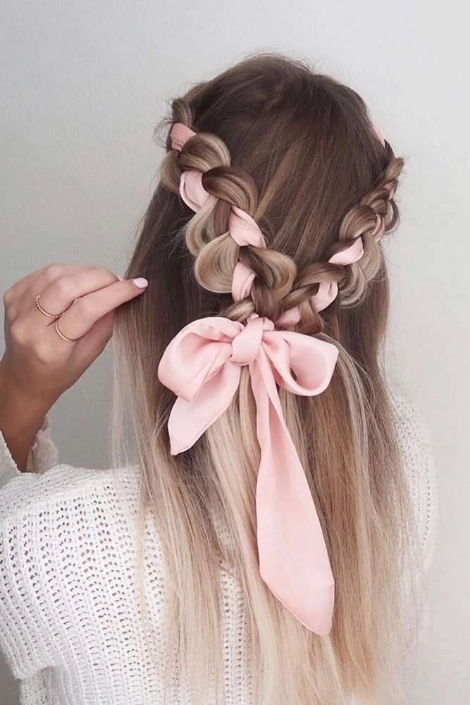 Elegant prom hairstyle featuring velvet ribbons woven into soft curls