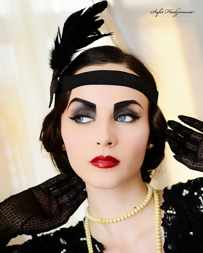 Elegant vintage 1920s flapper prom hairstyle with finger waves and a decorative headband