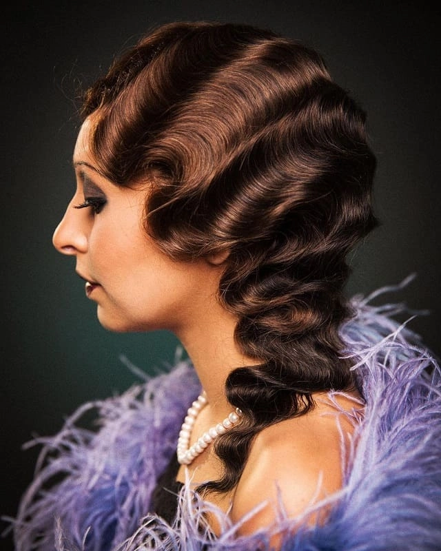 Elegant vintage 1920s flapper prom hairstyle with soft finger waves and a decorative hairpiece
