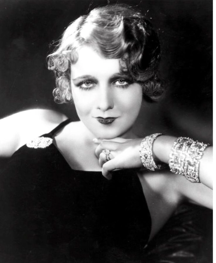 Vintage 1920s flapper prom hairstyle featuring finger waves and a decorative headband