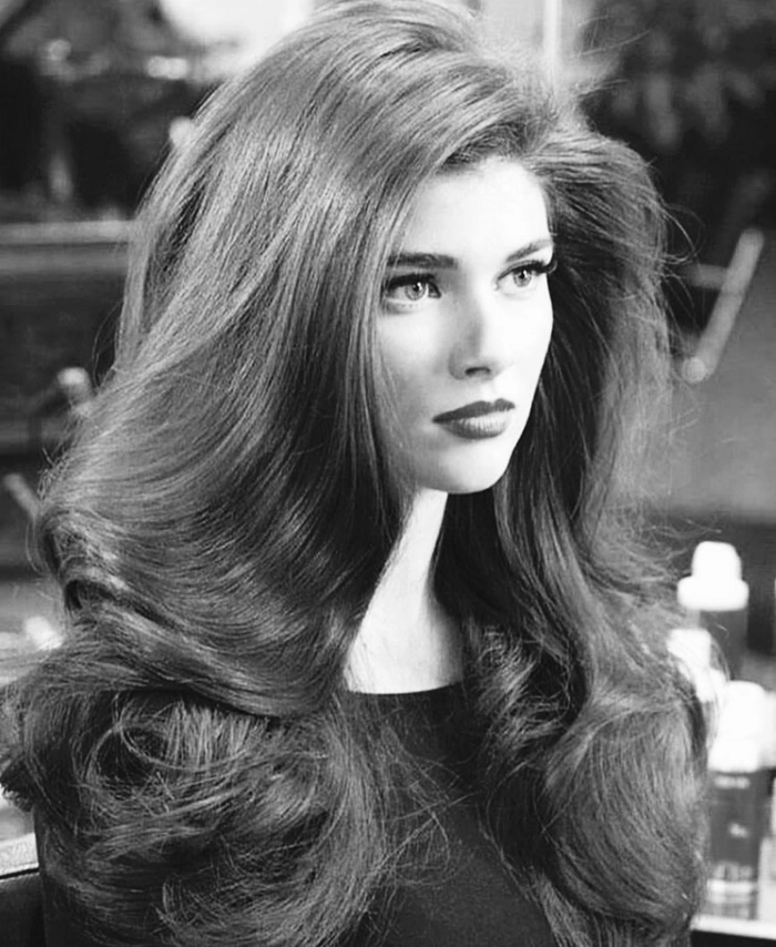 Voluminous blowout prom hairstyle with soft curls and extra volume