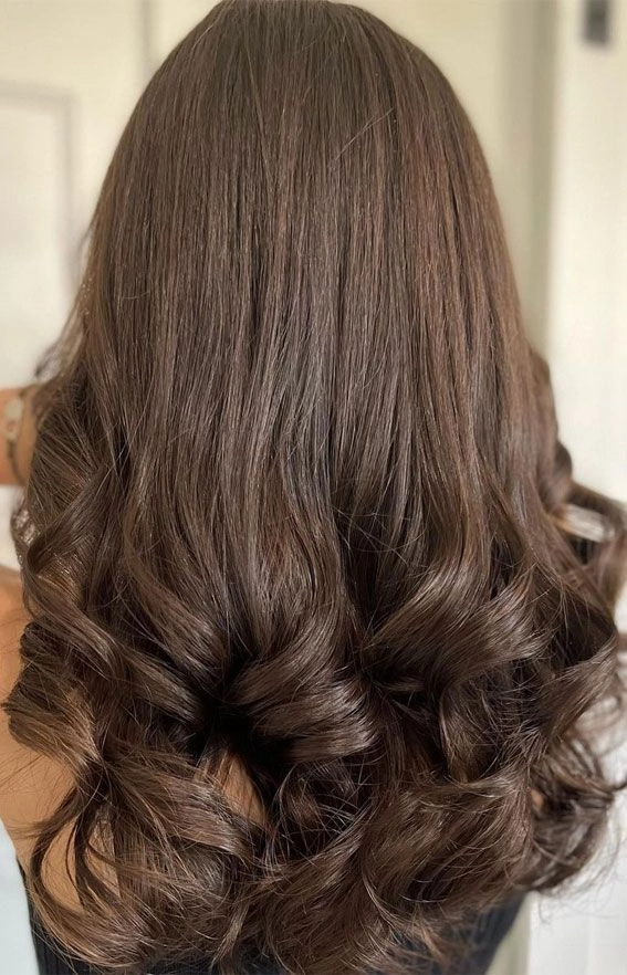 Voluminous blowout prom hairstyle with soft curls and elegant volume