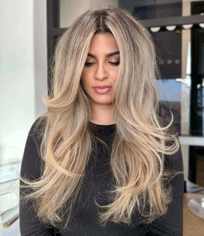 Voluminous blowout prom hairstyle with soft waves and glamorous volume