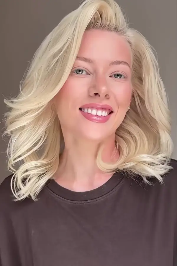 Voluminous blowout prom hairstyle with soft waves and elegant volume