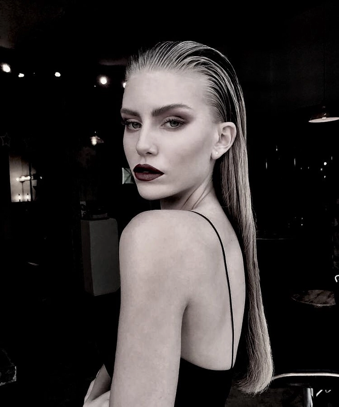 Elegant wet look slicked back prom hairstyle with glossy finish