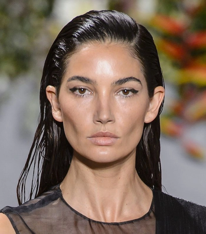 Wet look slicked back prom hairstyle with glossy finish and elegant styling
