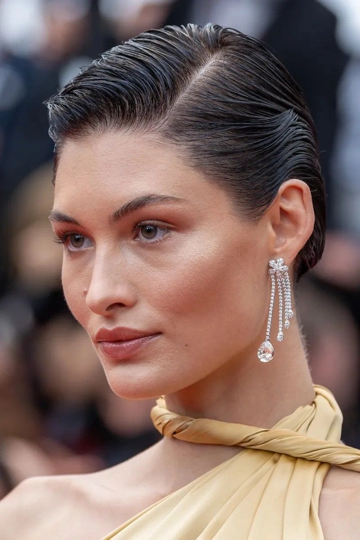 Wet look slicked back prom hairstyle with glossy finish and elegant flair