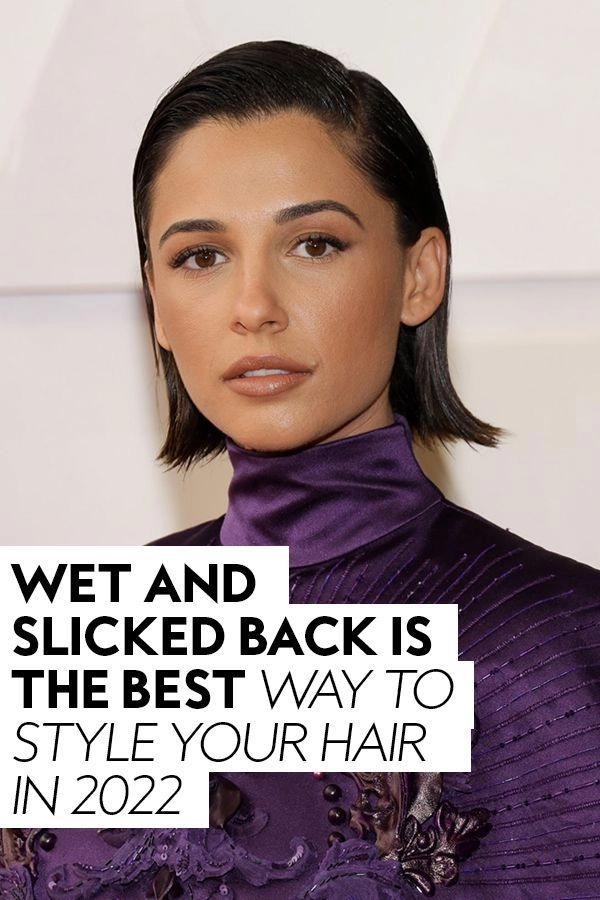 Woman with wet look slicked back prom hairstyle wearing elegant dress