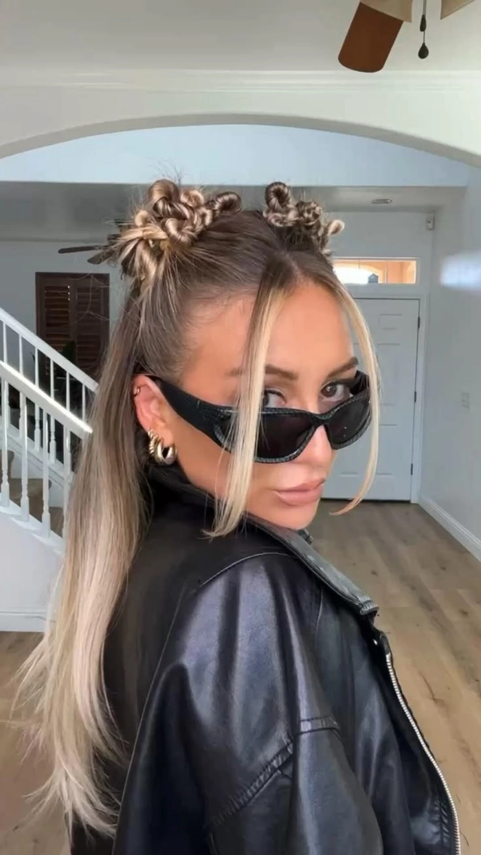 Y2K inspired space bun prom hairstyle with sleek baby hairs and glitter accents