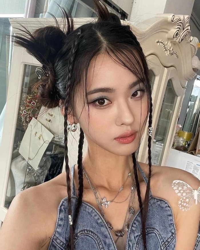 Y2K inspired space bun prom hairstyle with sleek finishes and glitter accents