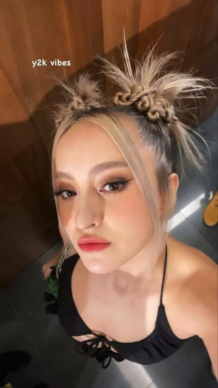Y2K inspired space bun prom hairstyle with colorful highlights and playful accessories