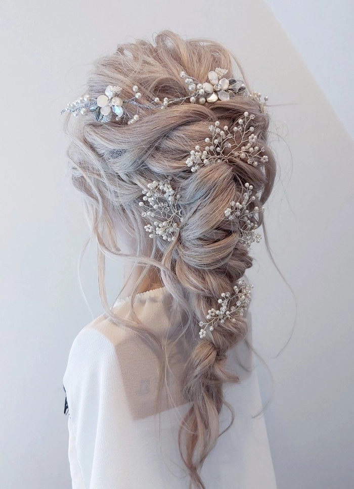Boho braided wedding hair with loose waves and floral accents