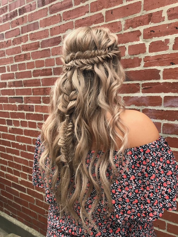 Boho braided wedding hair styled with soft waves and floral accents