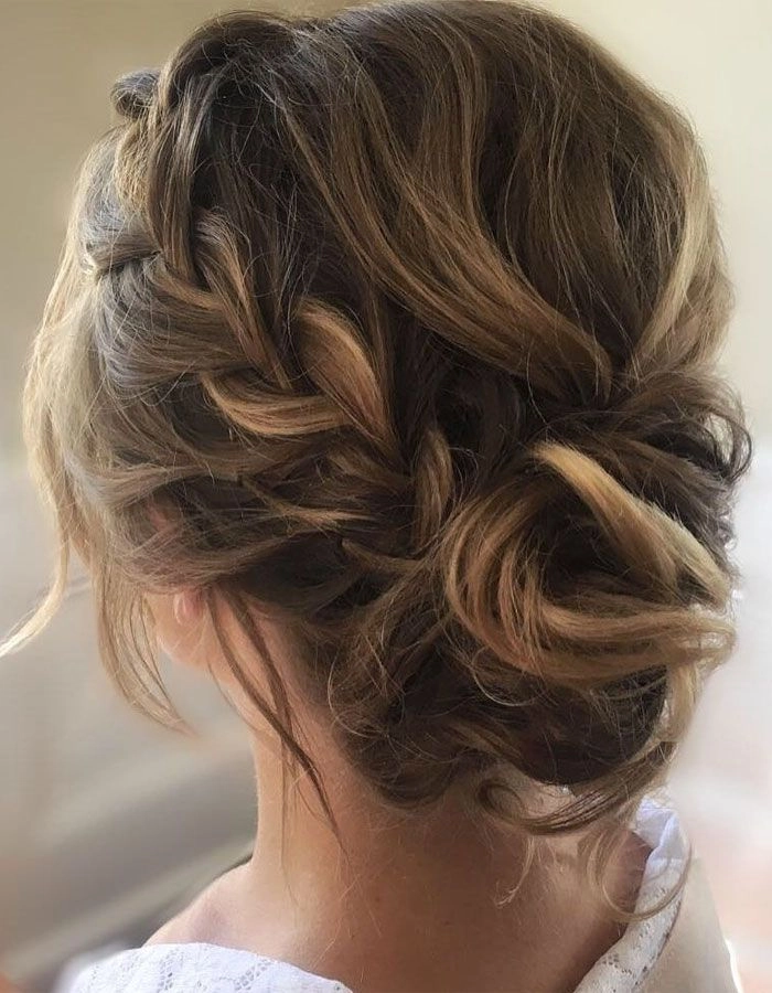 Boho bride with intricately braided wedding hair and floral accents