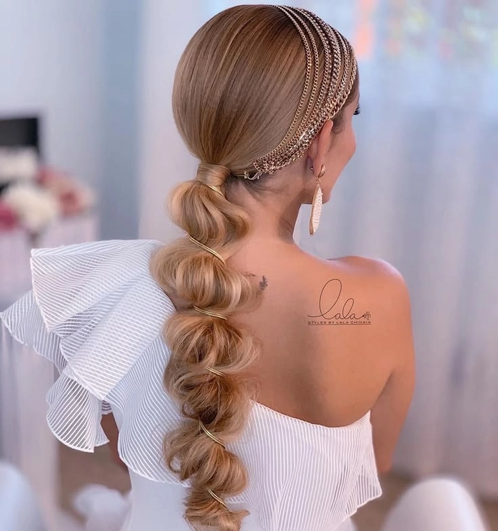 Elegant bridal hair bubble ponytail styled with delicate accessories for a wedding