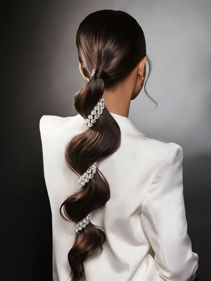 Elegant bridal hair bubble ponytail with soft curls for a romantic wedding look