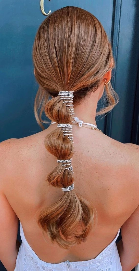 Elegant bridal hair bubble ponytail with soft waves for a wedding look