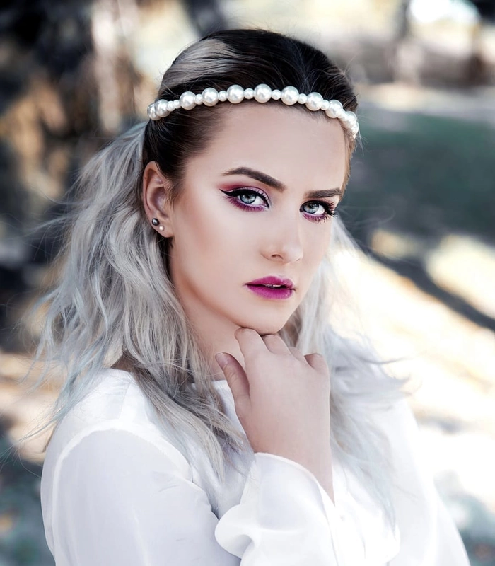 Elegant bridal hair for gray hair with soft curls and floral accessories