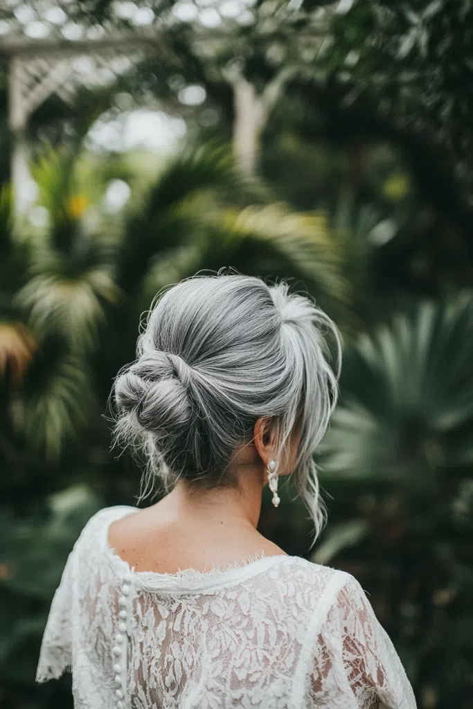 Elegant bridal hair for gray hair styled with delicate floral accents