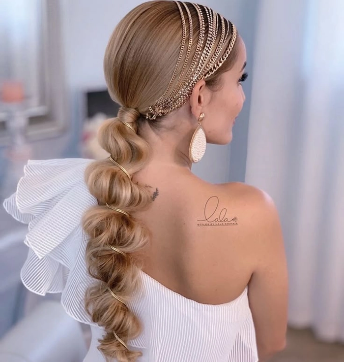 Elegant bridal hair bubble ponytail adorned with delicate floral accessories