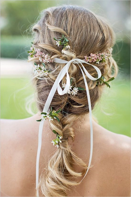 Elegant wedding hairstyle featuring fresh floral accents for brides Bridal hair styled with delicate fresh flowers for a romantic wedding look