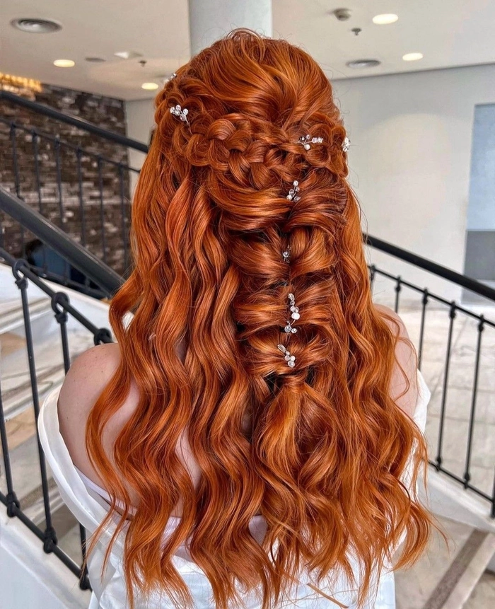 Elegant bridal hair for redheads styled with soft curls and floral accents