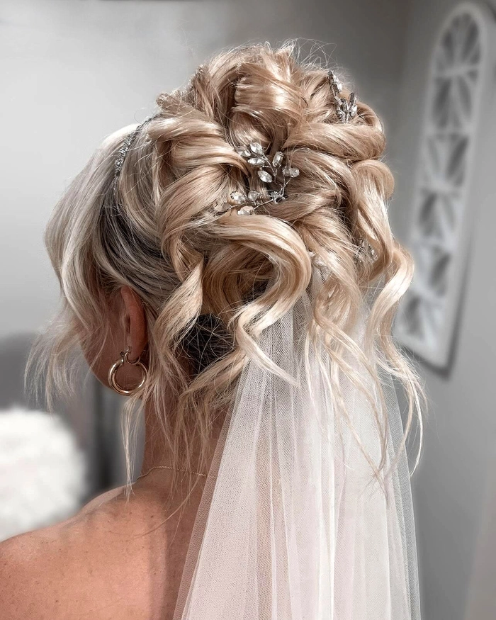 Bridal Hairstyles with Cathedral Veil featuring classic updo and flowing lace veil Elegant bridal hairstyle showcasing a cathedral veil with intricate lace details