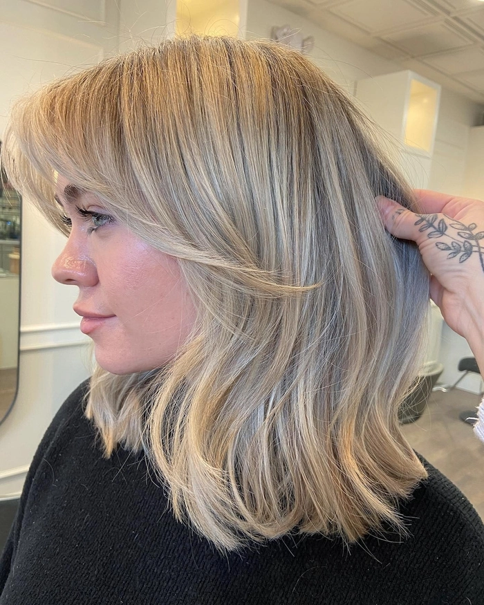 Elegant bridal hairstyle featuring curtain bangs with soft curls