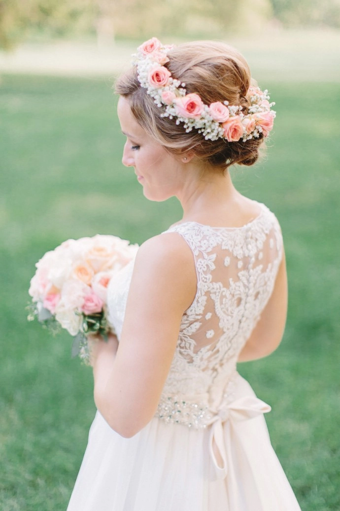 Elegant wedding hairstyle featuring fresh floral accents in soft curls Bridal hairstyle decorated with fresh flowers for a romantic wedding look
