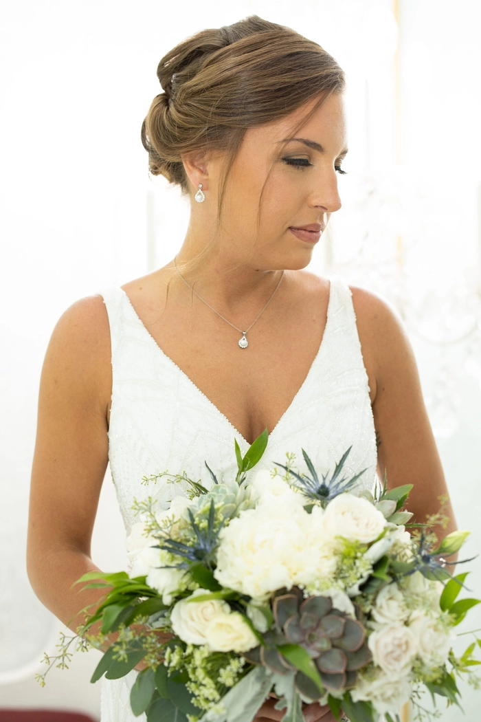 Bridal hairstyle perfect for a heart shaped face featuring soft waves and delicate accessories