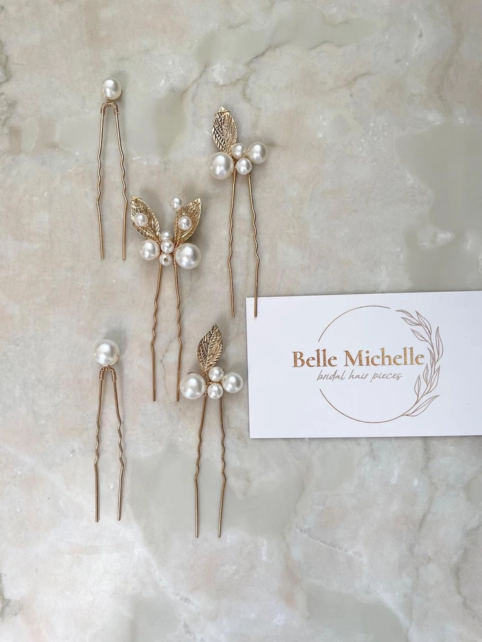 Wedding Hairstyles Image 4 showcasing bridal hair with delicate pearl accessories Bridal hairstyle featuring elegant pearl hair pins woven into soft curls