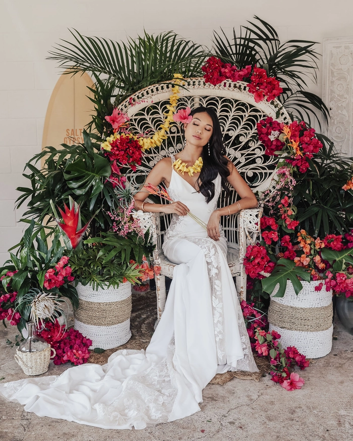 Tropical wedding hair inspiration for a beach ceremony look Elegant bridal hairstyle for a destination tropical wedding with flowers