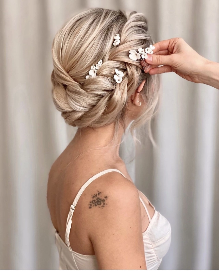 Bridal milkmaid braids hairstyle perfect for a romantic wedding day appearance Elegant bridal milkmaid braids styled with delicate floral accents for a wedding look