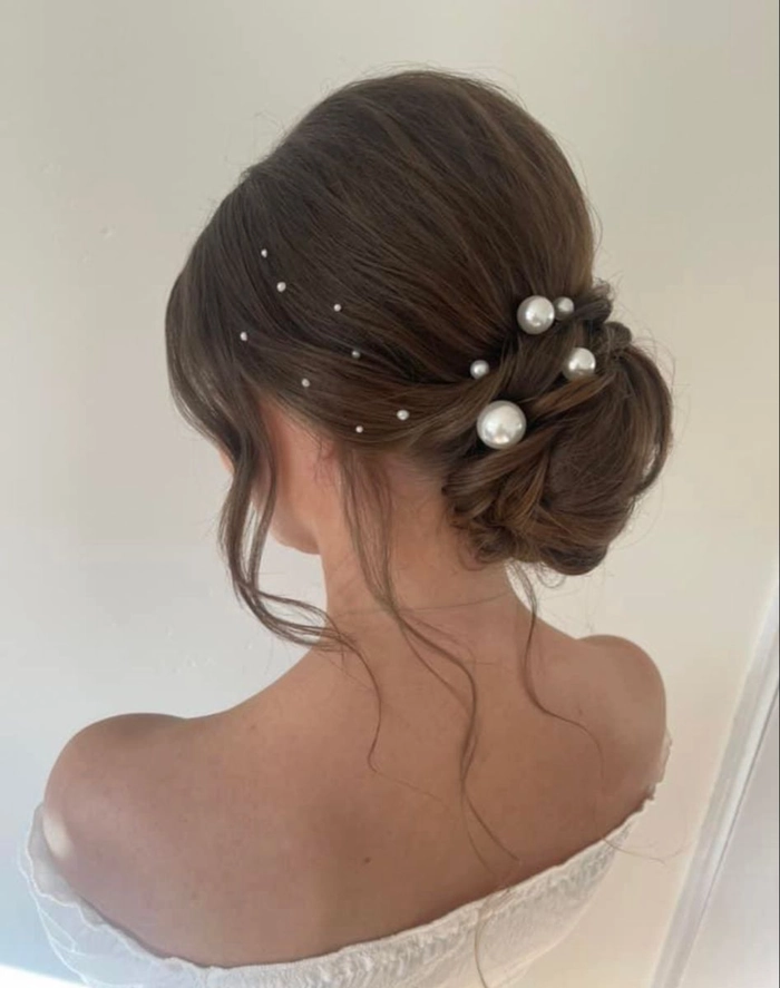 Wedding Hairstyles 14 showcasing bridal hair with pearl hair pins Bridal hairstyle featuring elegant pearl hair pins with soft curls