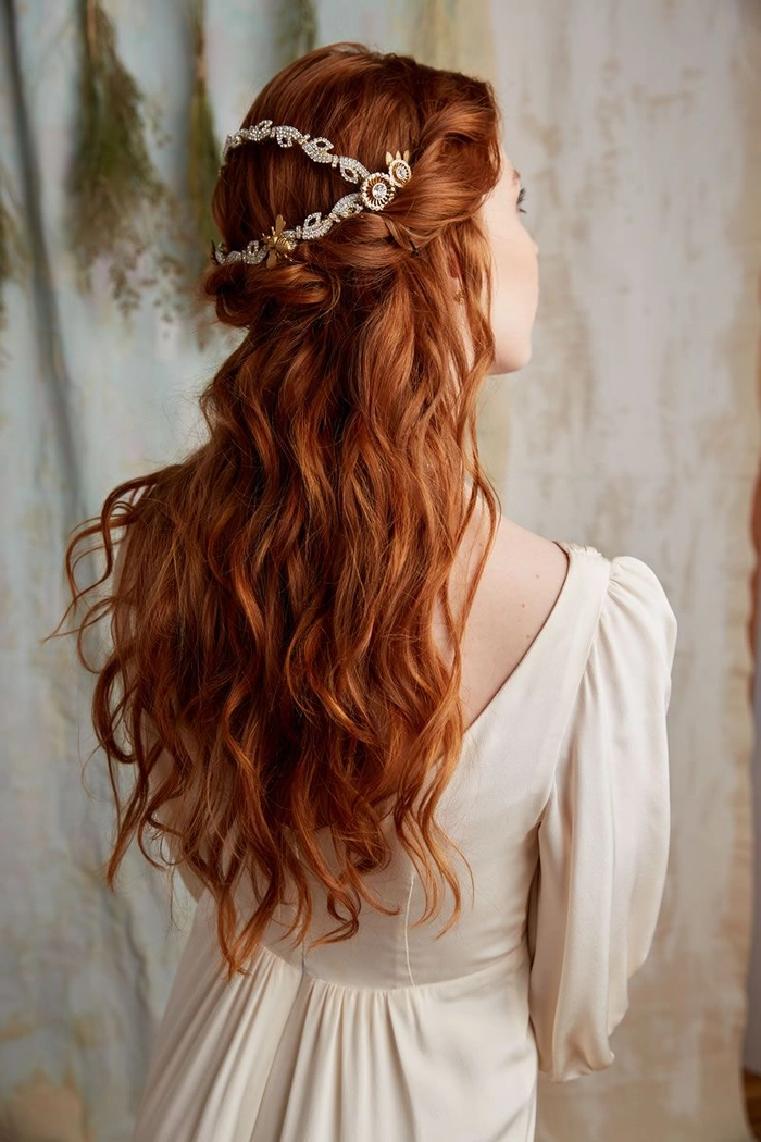 Elegant bridal hair for redheads styled with soft curls and delicate floral accents