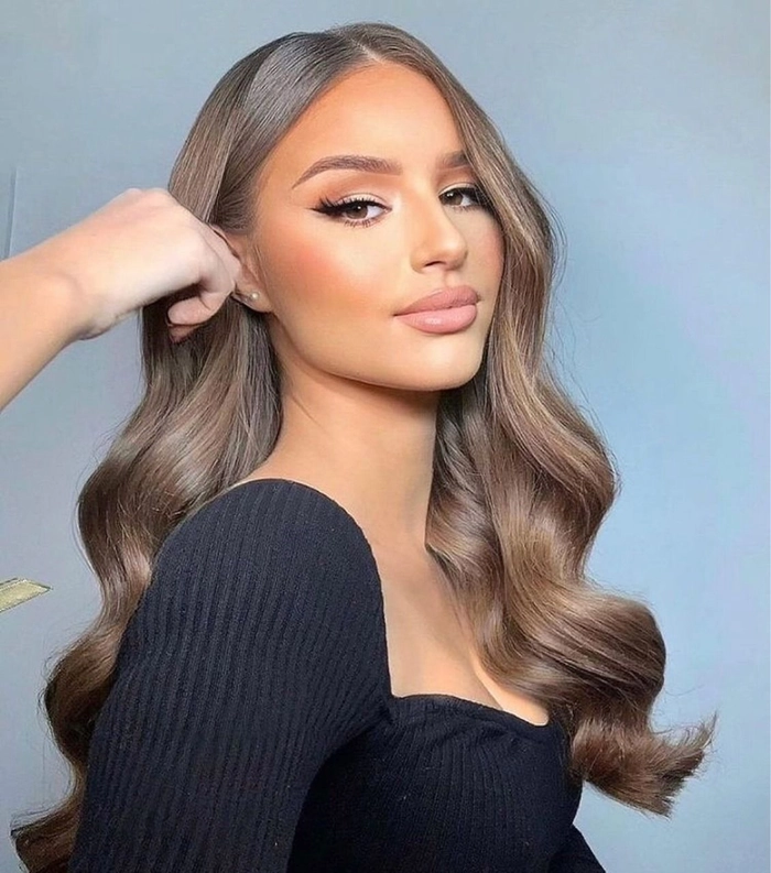 Bridal hairstyle featuring long straight sleek hair for a modern wedding look