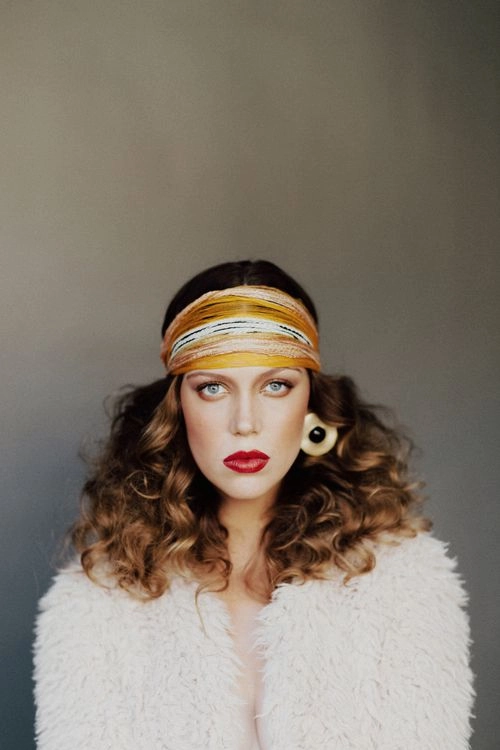 Bride with voluminous 70s style hair in a disco era bridal hair wedding look