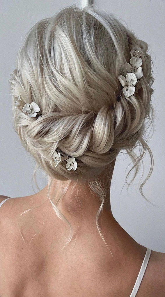 Romantic wedding hairstyle featuring a detailed braided crown perfect for special occasions Bride with an elegant wedding hair braided crown hairstyle adorned with delicate flowers